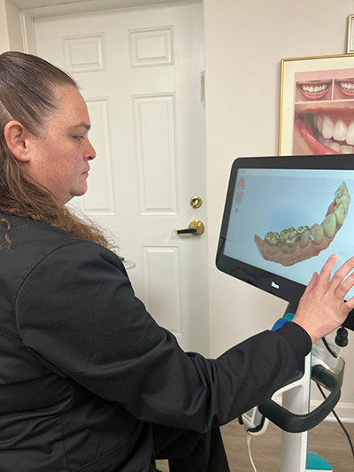 hygienist reviewing a patient's x-rays at Smile Design Center