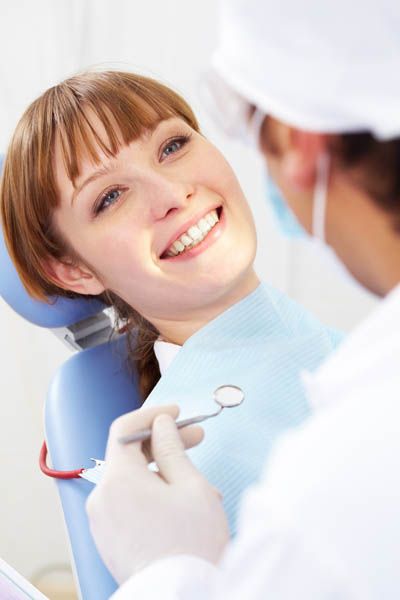 woman smiling during her first dental appointment at Smile Design Center