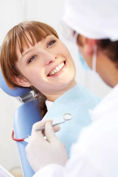 woman smiling during her first dental appointment at Smile Design Center