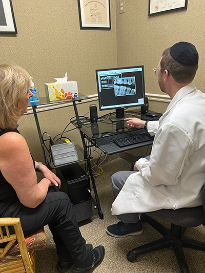 Dr. Yehuda Lehrfield discussing a patients x-rays with her